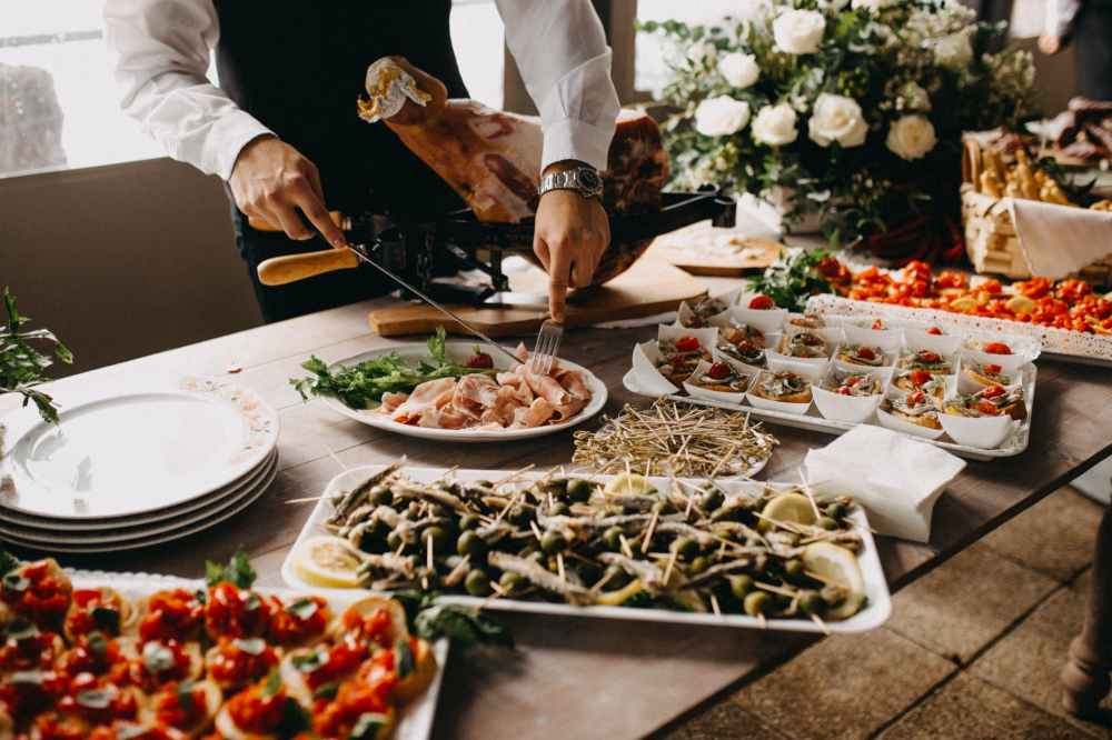 standing person using fork and knife on preparing food