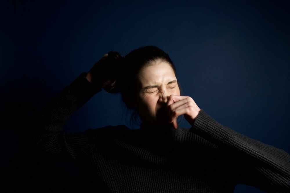 woman touching her nose