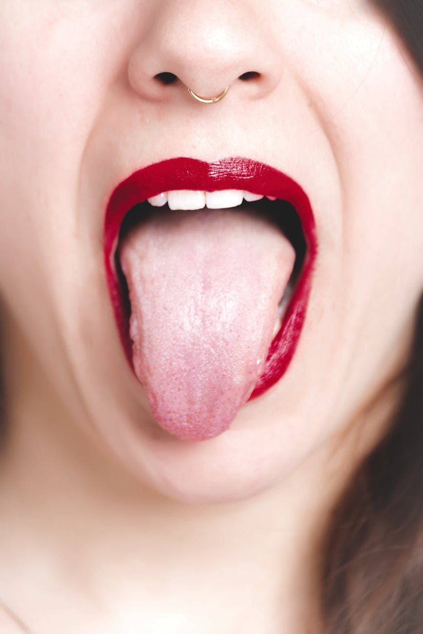 photo of woman showing her tongue